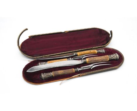 A Victorian silver repousse and deer antler leather and red velvet cased four piece carving set by Taylor of Sheffield, handl