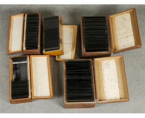 Five wooden boxes of Victorian glass projector slides. Each box with a hand written description of contents to the lid. Vario