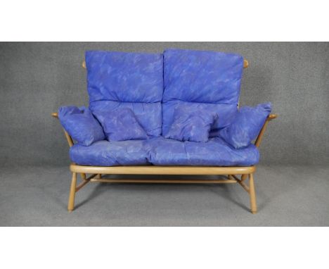 A vintage beech Ercol Evergreen two seater sofa. H.100 W.144 D.75cm 