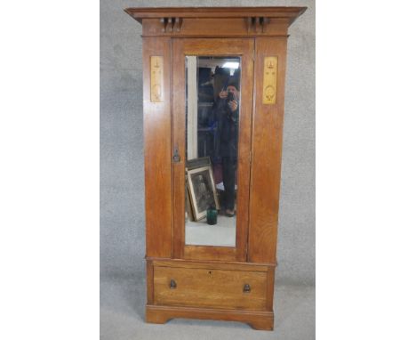 A late 19th century light oak Arts and Crafts wardrobe with Glasgow school inspired inlaid panels. H.200 W.83 D.43cm 