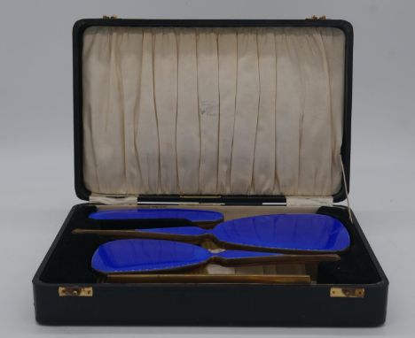 A leather effect cased Art Deco engine decorated cobalt blue enamel on silver deposit four piece brush and comb set. Makers p