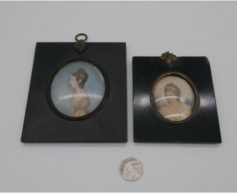 Two ebony framed and glazed 19th century portrait miniatures on ivory, brass acorn detailing to the wall fittings. One of an 