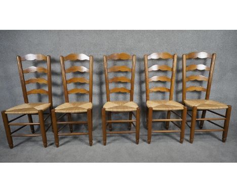 A set of five antique style country ladder back dining chairs with rush seats on stretchered supports. H.108 W.42 D.38 