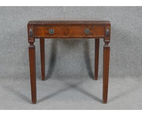 A Georgian style mahogany lamp table on fluted square tapering supports. H.60 W.55 D.55cm 