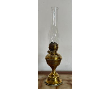 A Victorian brass oil storm lamp with clear glass tulip shade