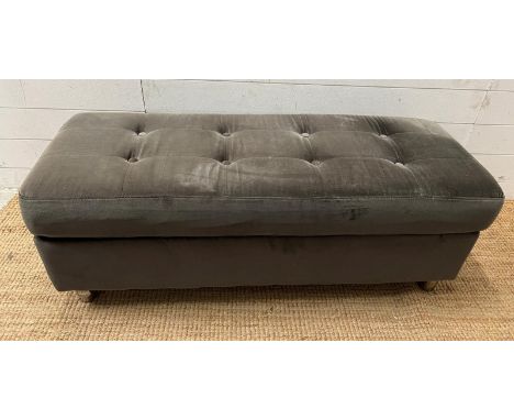 A velvet ottoman with button back detail (H42cm W117cm D46cm)