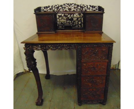 A Chinese 19th century rectangular hardwood desk, with scroll pierced prunus blossom gallery above two rectangular compartmen