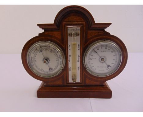 An Edwardian mahogany desk barometer and thermometer on raised square plinth