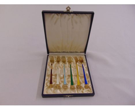 A cased set of Danish yellow metal and enamel pastry forks