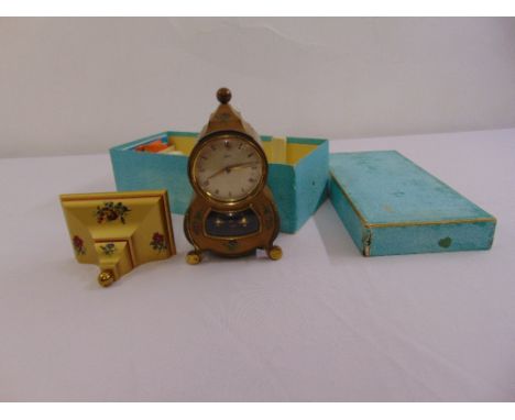 A Schatz mantle clock of shaped oval form with wall bracket and original packaging