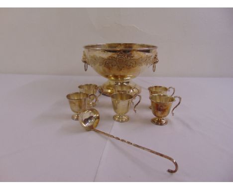 A silver plated punch bowl, six silver plated cups and a silver plated ladle