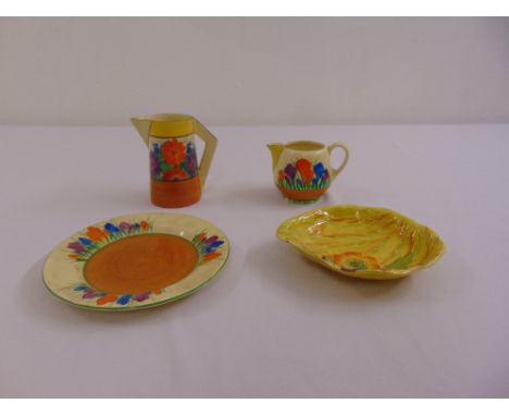 A quantity of Clarice Cliff to include a Bizarre Gay Day jug, a Crocus pattern milk jug, a Crocus plate and a Carltonware dis
