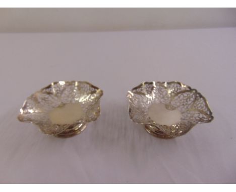 A pair of silver scroll pierced hexagonal bonbon dishes on raised circular bases, Sheffield 1958