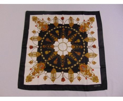 Hermes style silk scarf gold, black red and orange geometric forms against a white ground