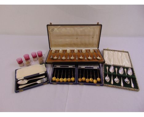 A quantity of cased silver, white metal and enamel spoons and six silver holders four with glasses