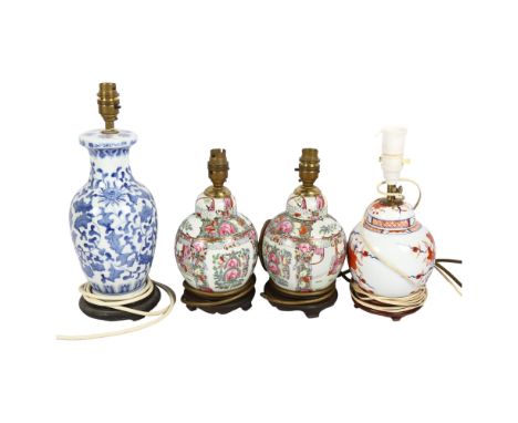 A Chinese blue and white table lamp on wooden stand, 36cm, a pair of Chinese enamelled table lamps and another, with 4 shades