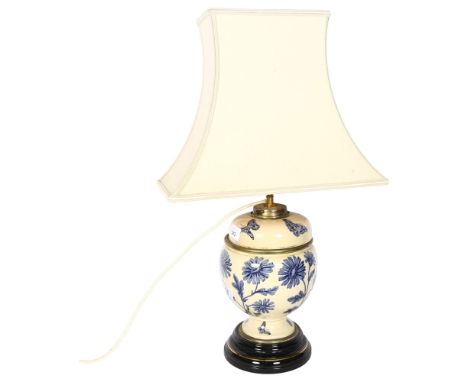 A ceramic table lamp with floral and butterfly decoration converted from an oil lamp, with shade, H58cm 