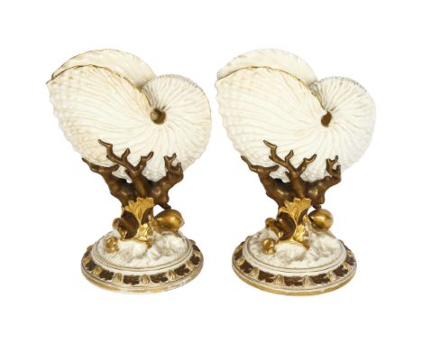 A pair of Edwardian Royal Worcester porcelain shell vases, on coral design supports and scallop decorated plinths, H21cm 