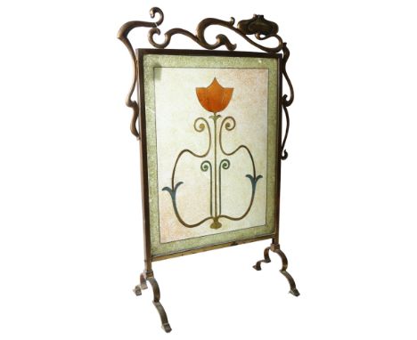 An Art Nouveau brass-framed fire screen with an inset stylised glass panel, bead and wirework decoration, H80cm, W50cmGlass p