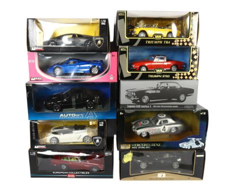 A quantity of 1:18 scale diecast vehicles, in original boxes, some with associated display stands, including such brands as S