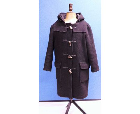 A lady's black duffle coat by Montgomery, single breasted with zip fastening and horn buttons, patch pockets and hood, size 3