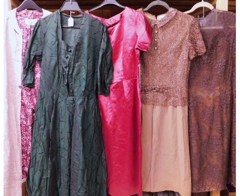 A selection of mid 20th Century lady's wear to include a fitted red short sleeved round necked cocktail dress, a green button
