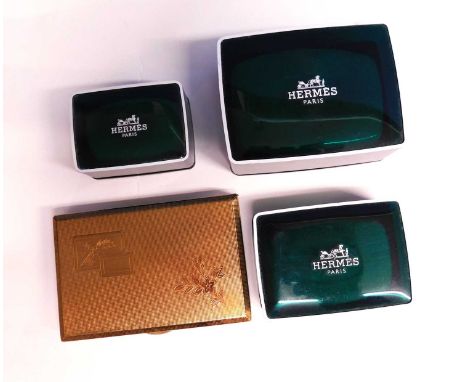 A lady's gilt metal compact, of rectangular form with powder and lighter compartment inside, together three Hermes travel siz