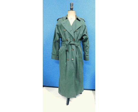 A lady's green Burberry trenchcoat, double breasted with side pockets, tie waste and buckle detail to cuff, shoulder epaulett