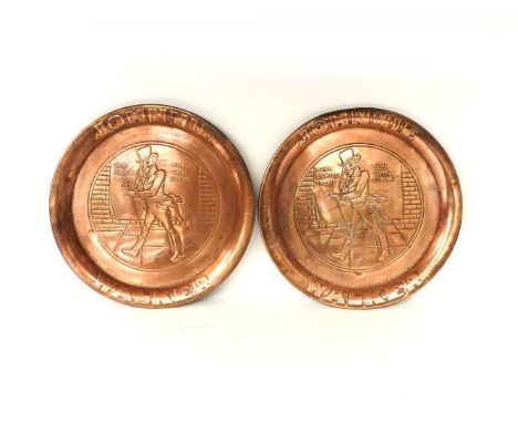 A pair of embossed copper circular trays, advertising Johnnie Walker Scotch Whisky, 33.8cm diameter