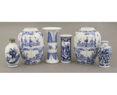 A pair of blue and white ovoid Vases, 19th century, in Kangxi style, the body divided into irregular panels of figures, preci