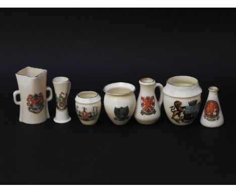 Two boxes of Goss crested wares, together with two related books, to include cups and saucers, lighthouses, the Salisbury Jac