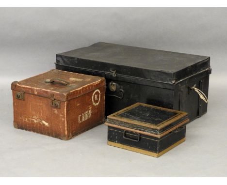 A large black trunk, a deed box, and a small square box