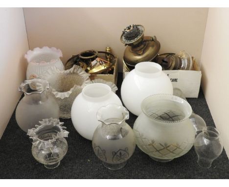 A collection of various oil lamp parts, burners, shades, etc