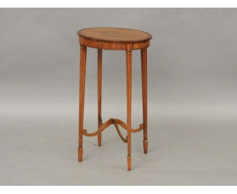 An Edwardian oval satinwood lamp table with rosewood cross banding and square taper legs, 74cm high