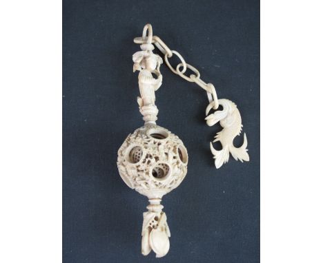 A CHINESE CARVED IVORY CONCENTRIC BALL OF SEVEN RETICULATED SECTIONS, the exterior overall decorated with figures and foliage