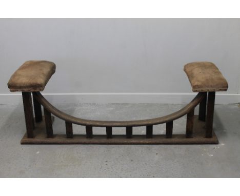 EARLY 20th CENTURY OAK CLUB FENDER having upholstered seats to each end, curved front rail on flat slats.  19" x 56.5" x 16.5