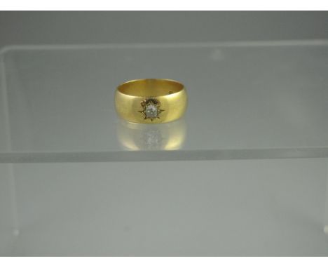 18ct GOLD BAND RING INSET WITH AN OLD CUT DIAMOND, estimated diamond weight 0.25cts.  Width of band 8mm.  Weight 8.4g. CONDIT