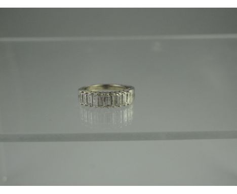 A WHITE METAL, DIAMOND HALF ETERNITY STYLE RING set with ten baguette cut diamonds.  Ring size L. CONDITION REPORT: In good c