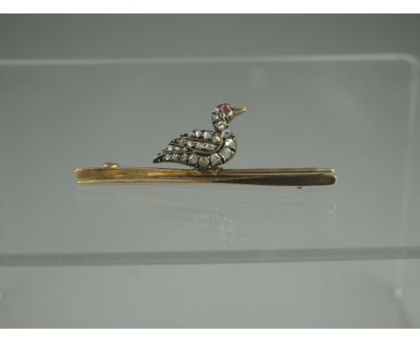 A LATE VICTORIAN DIAMOND BROOCH.  Modelled as a duck encrusted in rose cut diamonds with cabochon ruby eye sitting on two oar