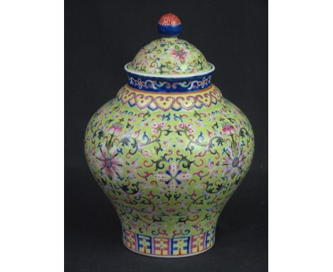 CHINESE PORCELAIN BALUSTER SHAPED JAR AND COVER overall decorated with enamelled floral and stylized scroll designs on a yell