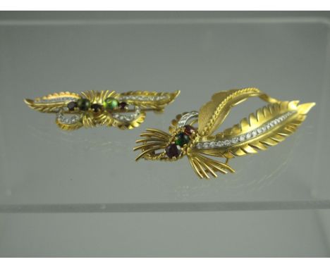 TWO 18ct GOLD, DIAMOND AND GEM SET LEAF BROOCHES.  Naturalistically modelled set with diamonds, garnets and peridot.  60mm x 