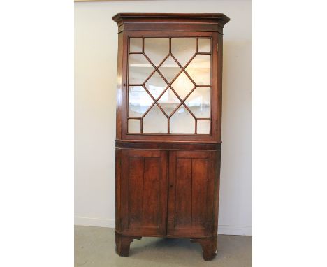 19th CENTURY WELSH OAK TWO STAGE DOUBLE CORNER CABINET having moulded cornice over single astragal glazed doors with two fitt