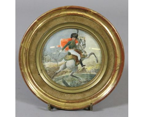 A circular gilt framed ivory portrait miniature of a French Hussar Officer of the Imperial guard after Theodore Gericault.