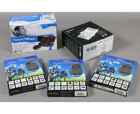 A boxed Wake and Shake alarm clock and a Garmin Edge bike GPS along with three boxed GPS bike travel computers.