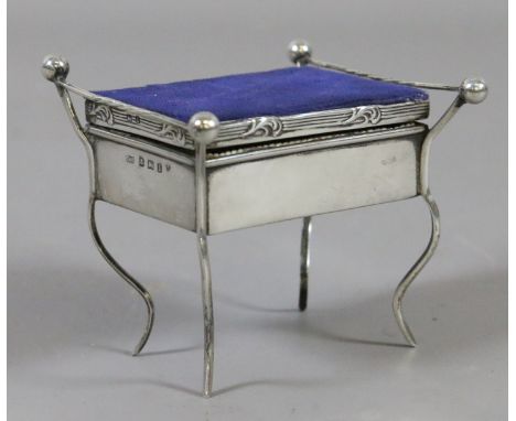 An Edwardian novelty silver trinket box in the form of a piano stool by Clark & Sewell. Assayed Birmingham 1910.