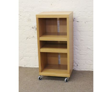 A modern light oak adjustable shelf unit on wheels.