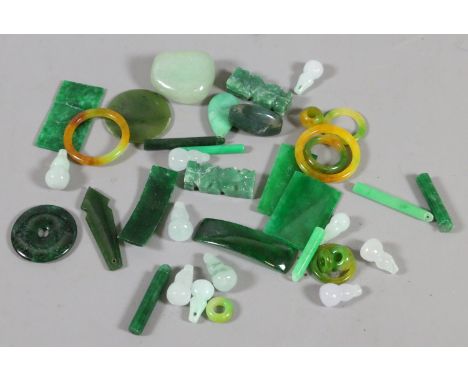 A box of mixed spinach and celedon jade trinkets.
