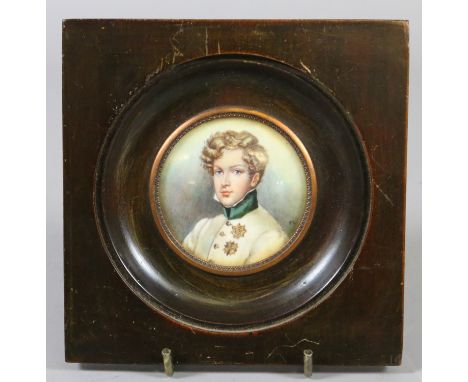 A Regency style ivory portrait miniature of Napoleon II King of Rome. Wearing a white tunic and a pair of gilt medals. Monogr