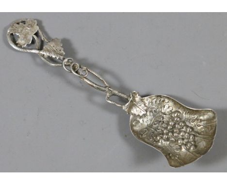 A Victorian silver caddy spoon by Holland & Thompson. Chased with leaves and berries and with openwork handle. Assayed Birmin