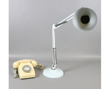 An anglepoise desk lamp along with an old B.T telephone.